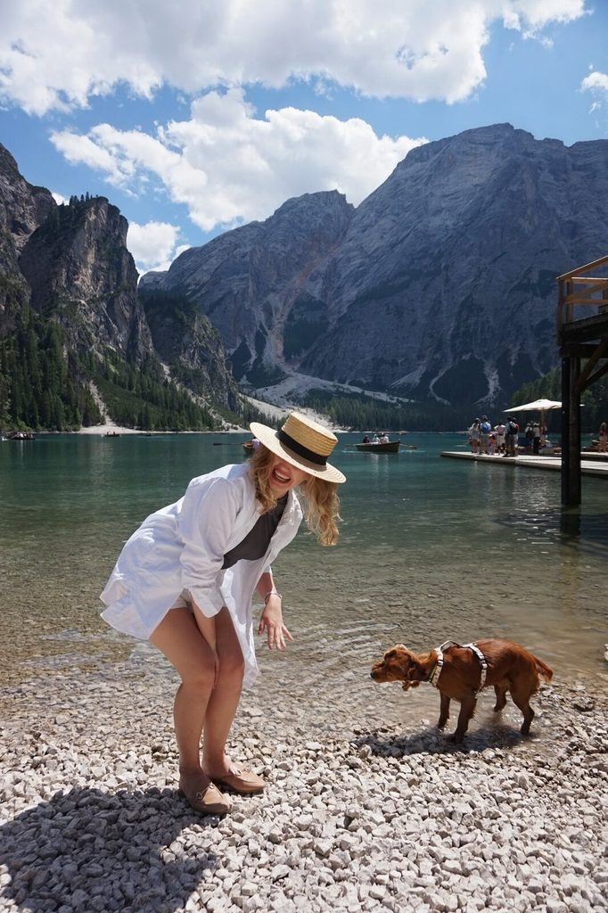 Ruslana travelling with her dog at Lago di Braies in the Dolomites